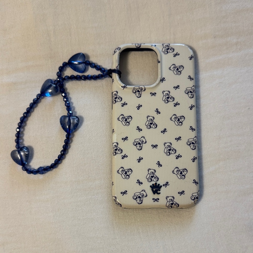 Velvet Caviar Teddy Bear Phone Case with Blue Beaded Strap (iPhone 15 Pro Max)